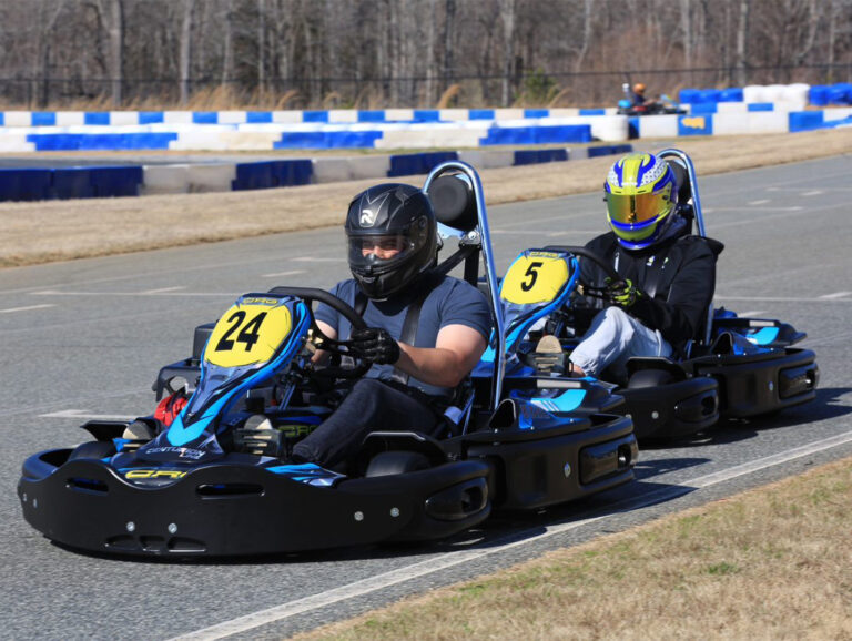 Two people racing in a kart on our track.